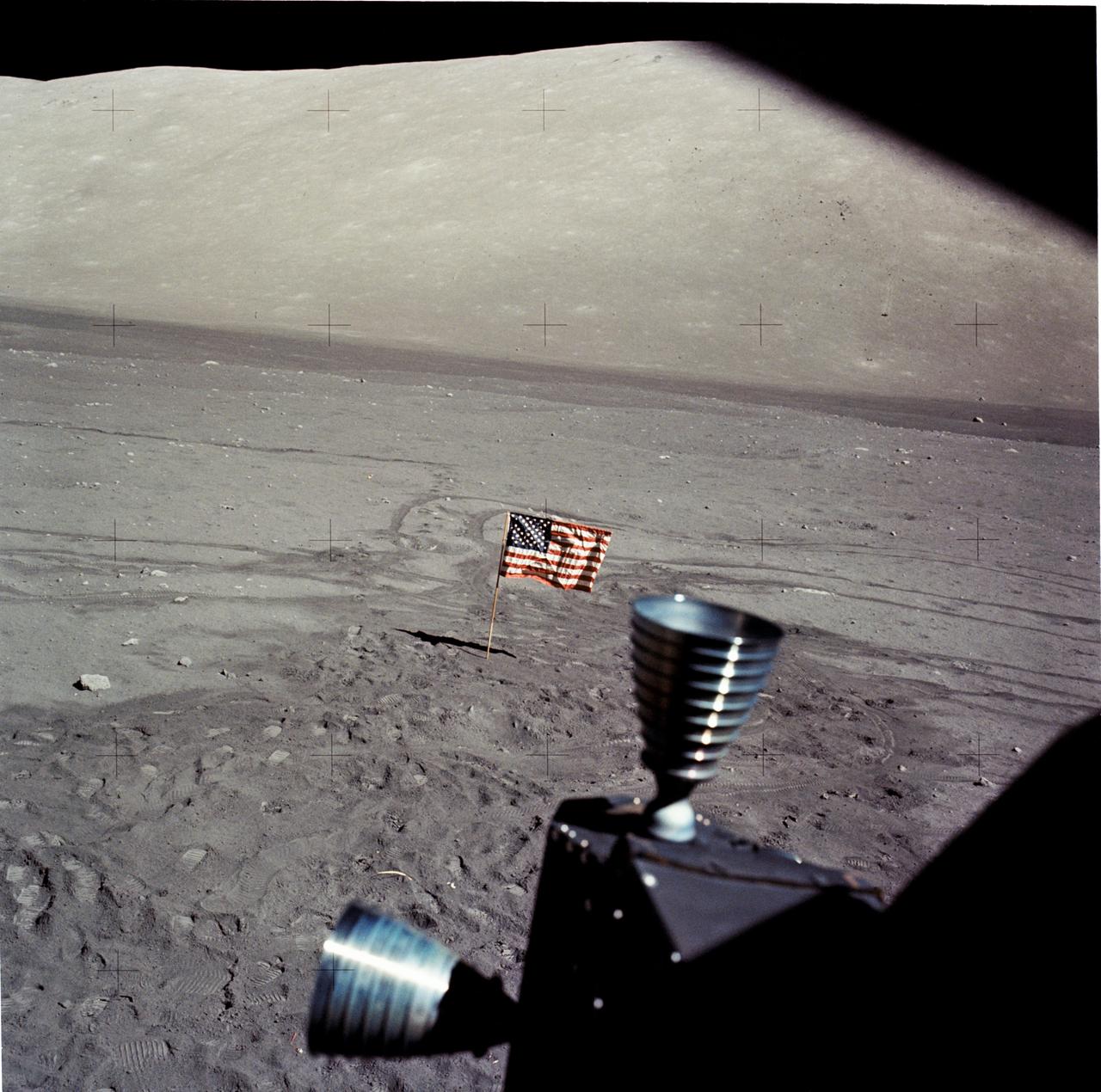 Apollo 17 view from a lunar module window, with thrusters in the foreground and the mountainous lunar surface beyond